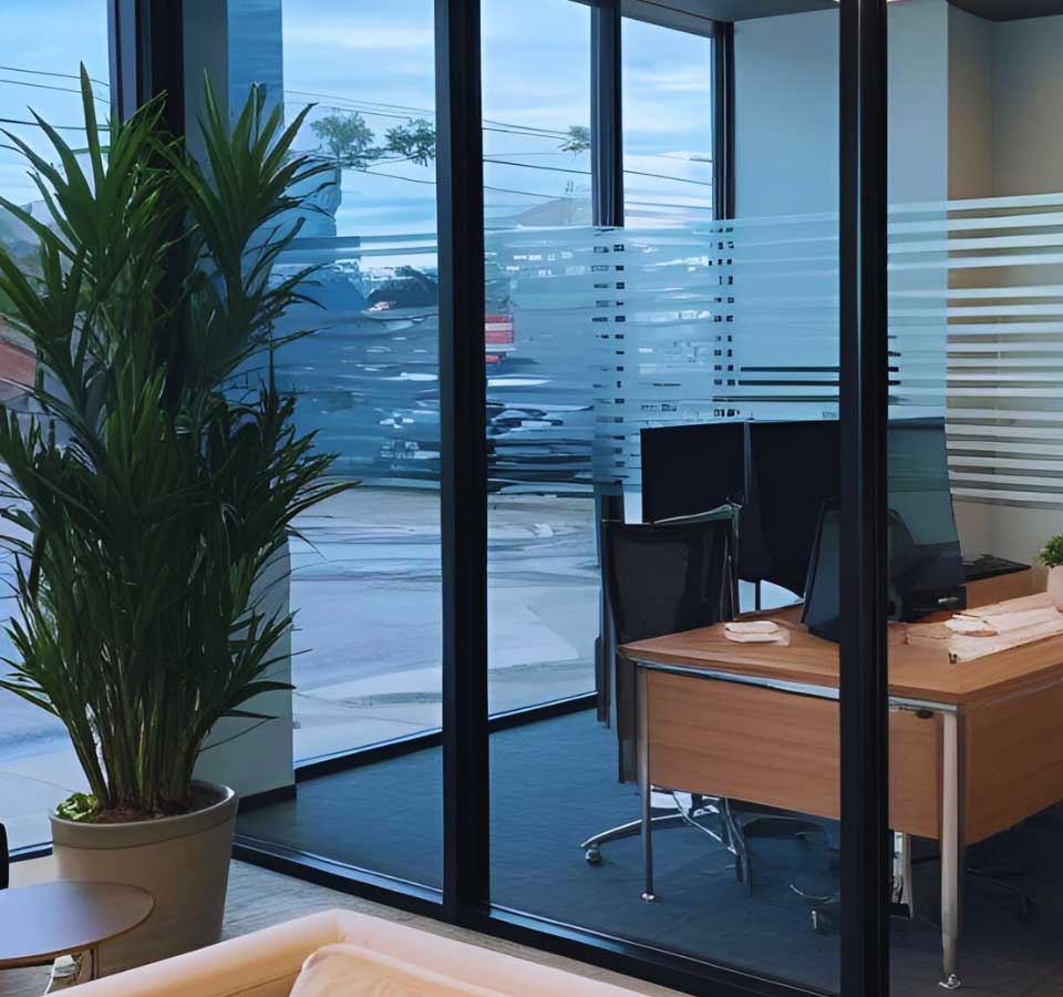 Modern workspace enhanced with striped frosted window tinting in Tulsa, OK